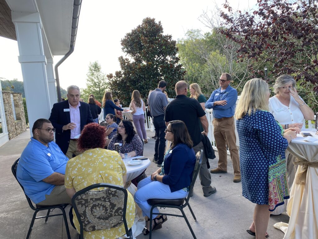 TELA cohort, committee, and Extension Administrative Members (EAM) networking at a reception.